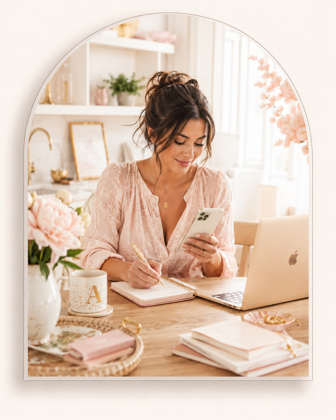 Woman planning her week on a phone at a kitchen table, cream and blush setting