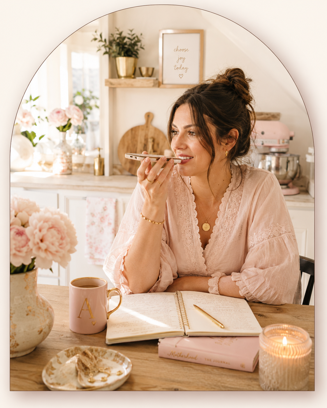 Woman talking into her phone at a kitchen table doing a voice brain dump